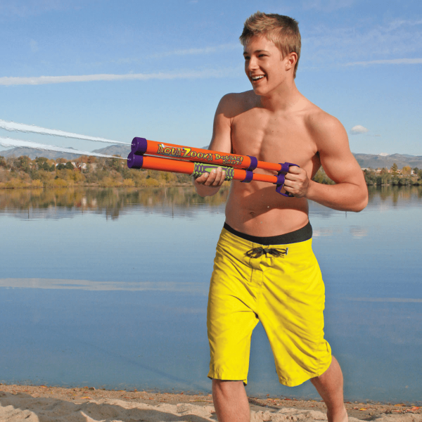 Action shot of a young person shooting the Aqua Zooka, with a double stream of water
